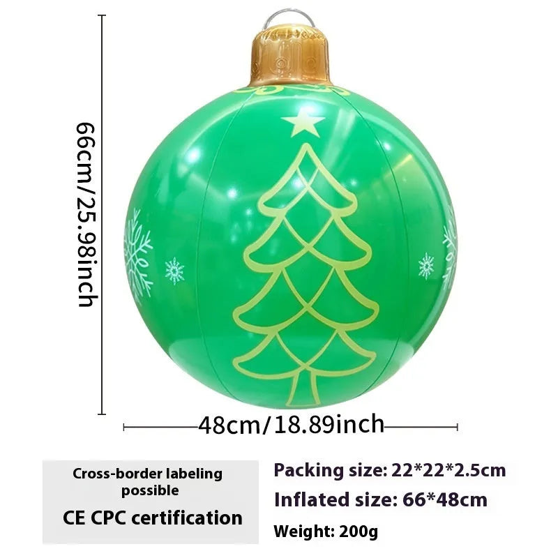Large red inflatable Christmas ball with snowflake design and LED lights in outdoor garden setting