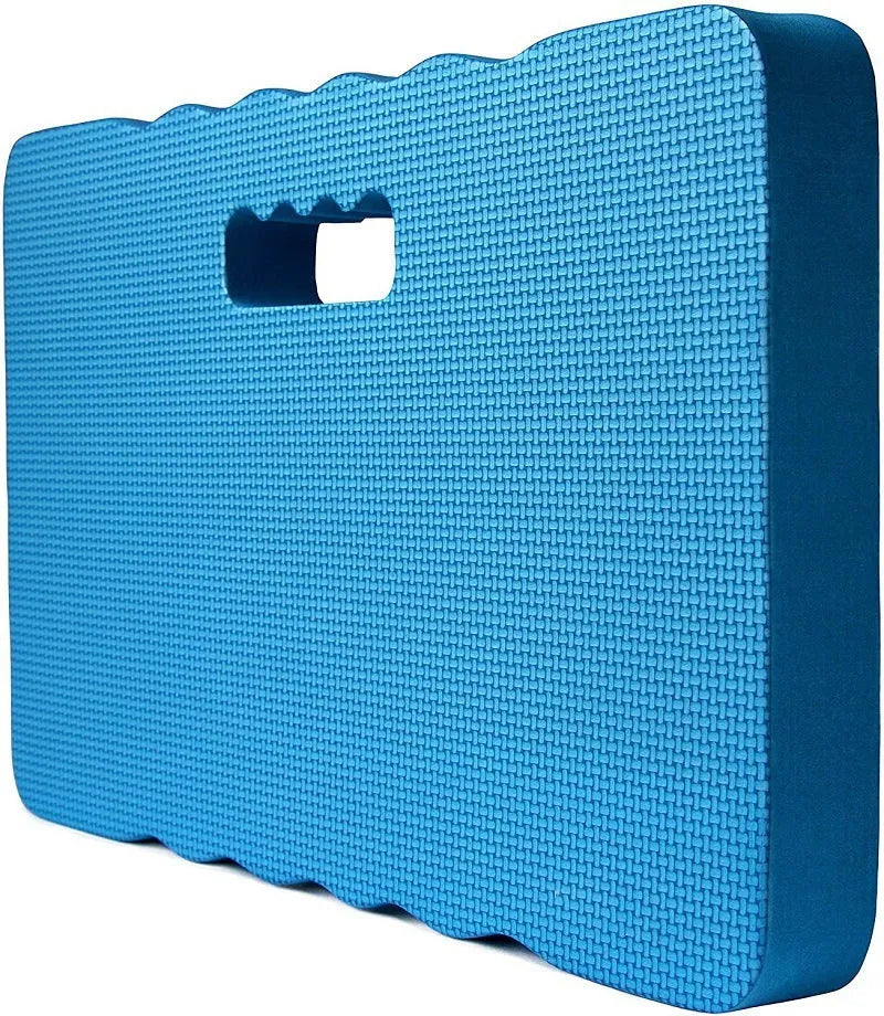 Blue garden kneeler pad with thick foam cushioning on soil next to plants