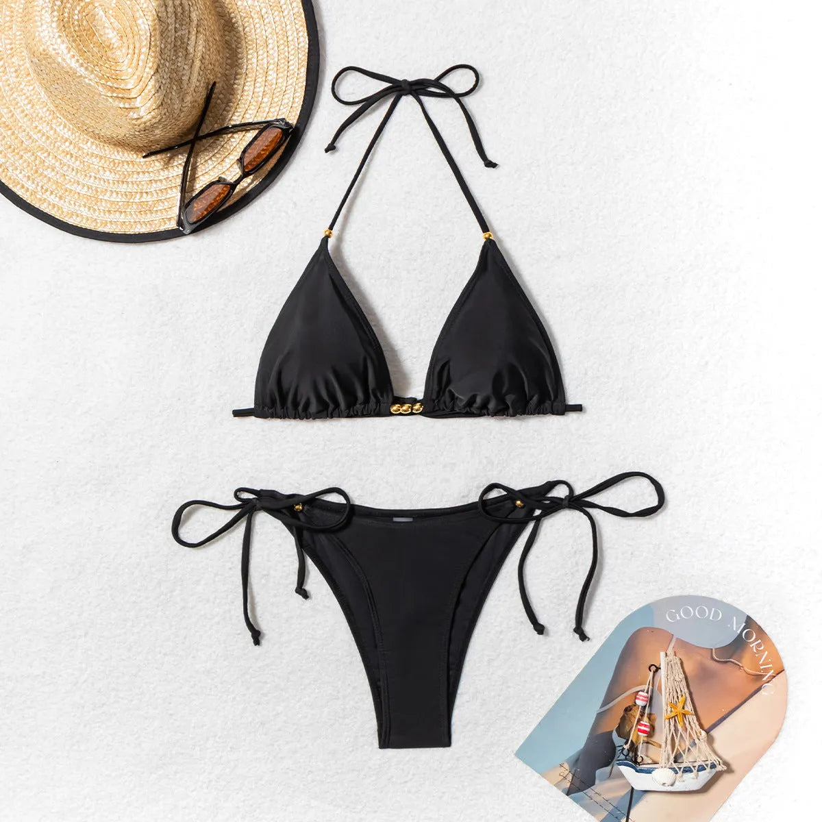 Black women's bikini swimsuit with metal bead detailing and split leg design
