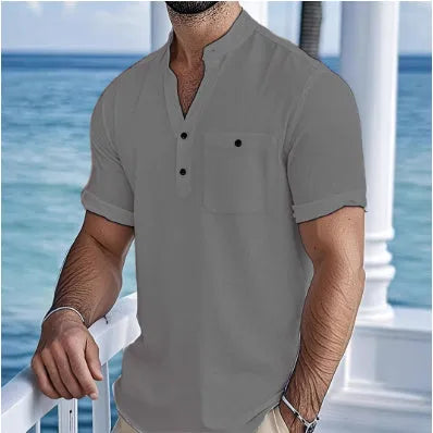 Man wearing a light blue linen-blend stand collar T-shirt with short sleeves and a loose fit.
