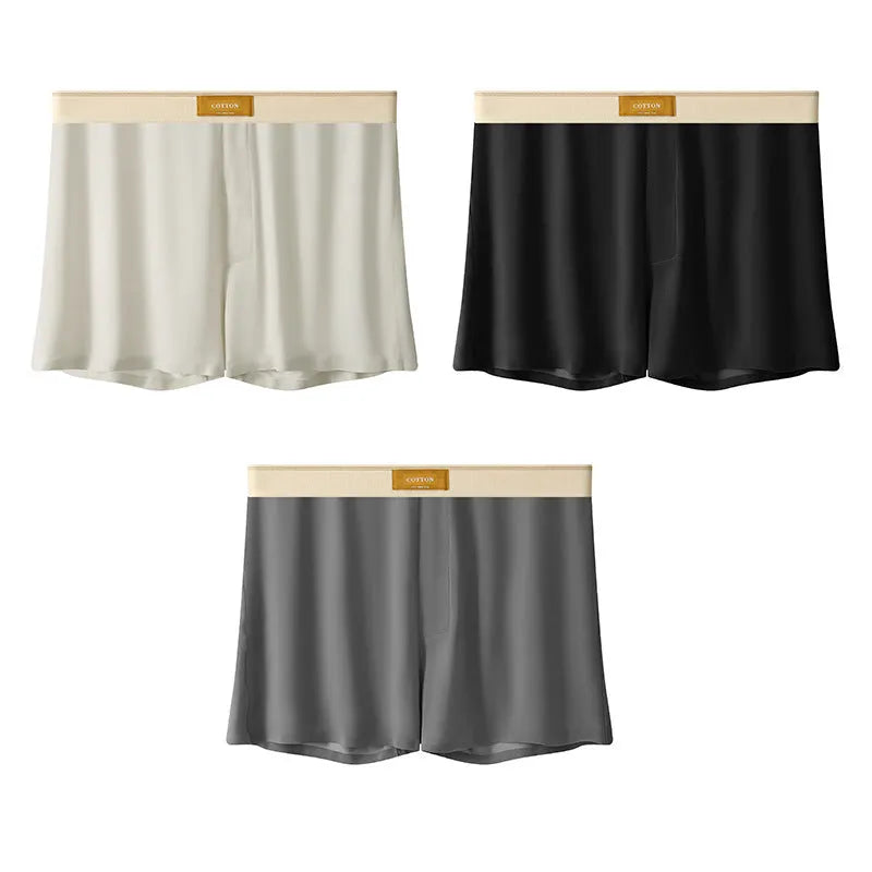 Pack of three pairs of men's solid colour ice silk underwear on a white background.