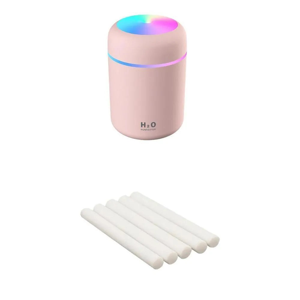 Pink USB portable humidifier with 300ml water tank on wooden desk surface