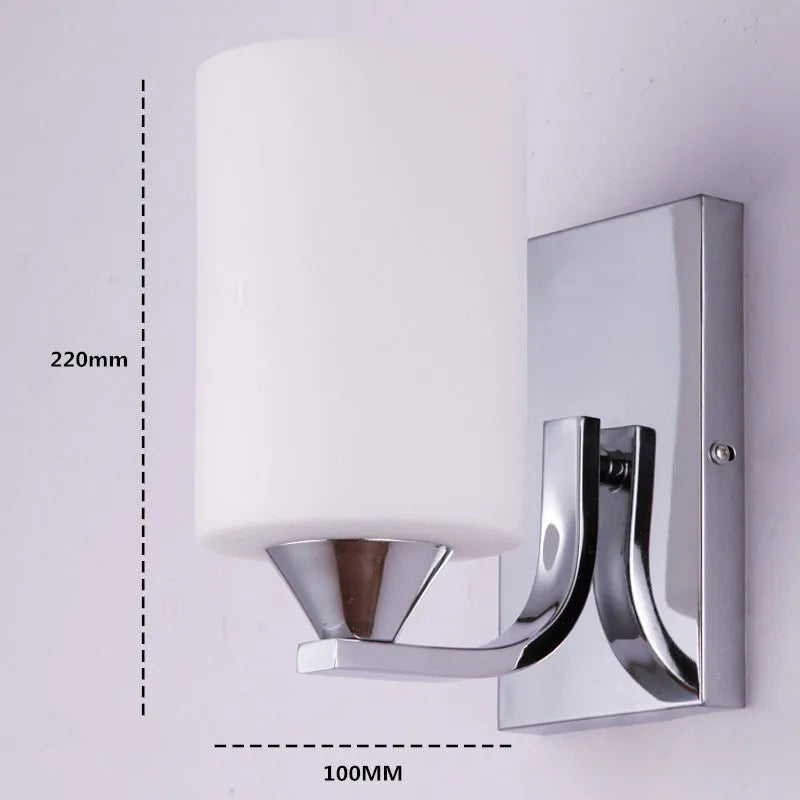 Modern chrome-finished wall lamp with a clear glass shade, shown in a single head configuration.