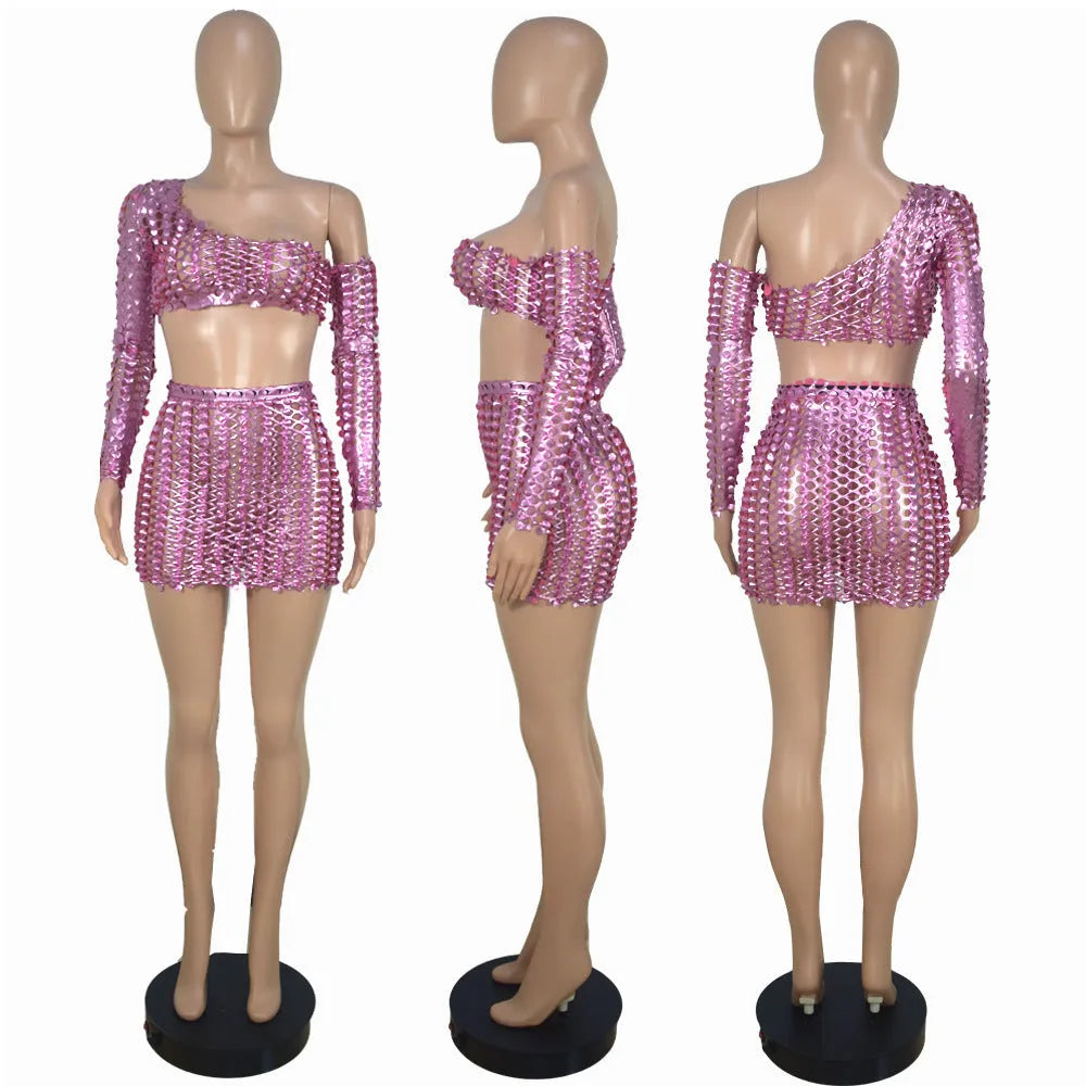 Women's black two-piece dress set with sleeveless top, short skirt, and hollow-out net detailing.