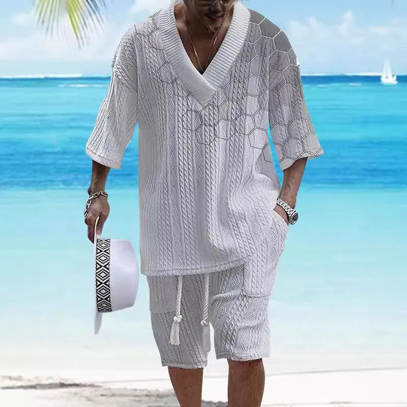 Man wearing a printed knitted drop-shoulder short-sleeved top with matching shorts from a co-ord suit set.