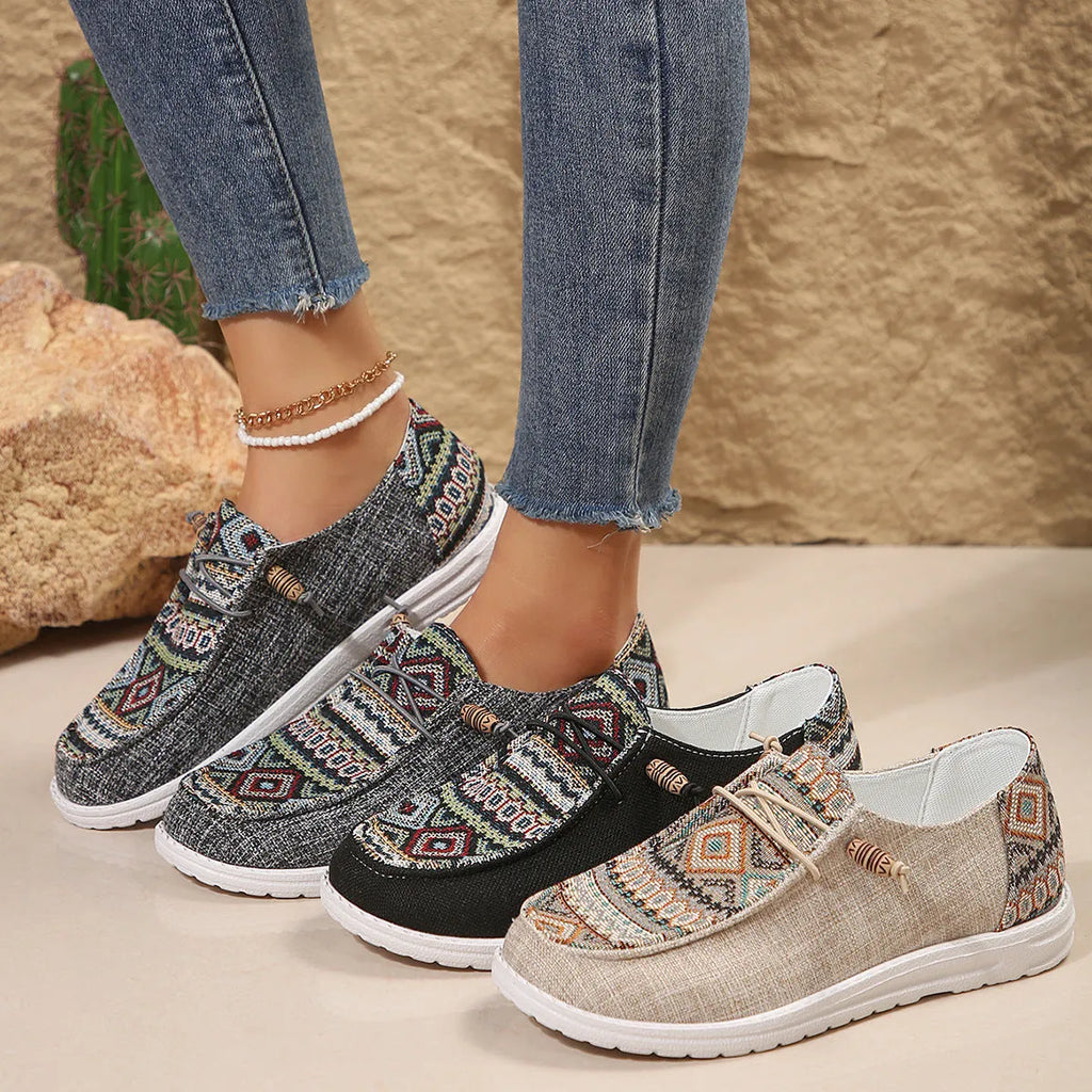 Women's flat round toe shoes in black, dark grey, and khaki with a low-top design and rubber sole.
