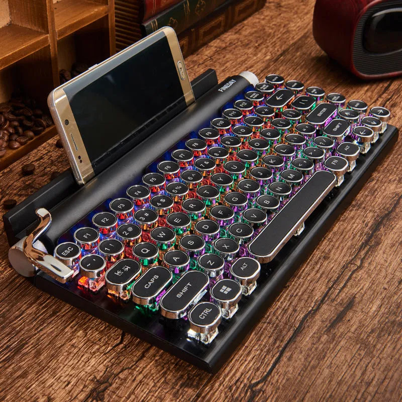 Black retro typewriter style mechanical keyboard with backlit keys on a desk