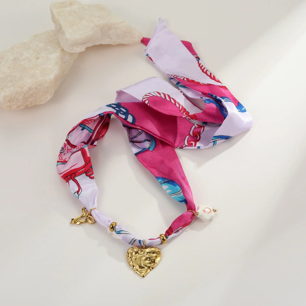 Stainless steel geometric pendant necklace and matching bracelet set with gold electroplating on a white background.