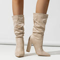 Women's black suede pointed-toe high heel boots with a chunky heel and middle calf length.