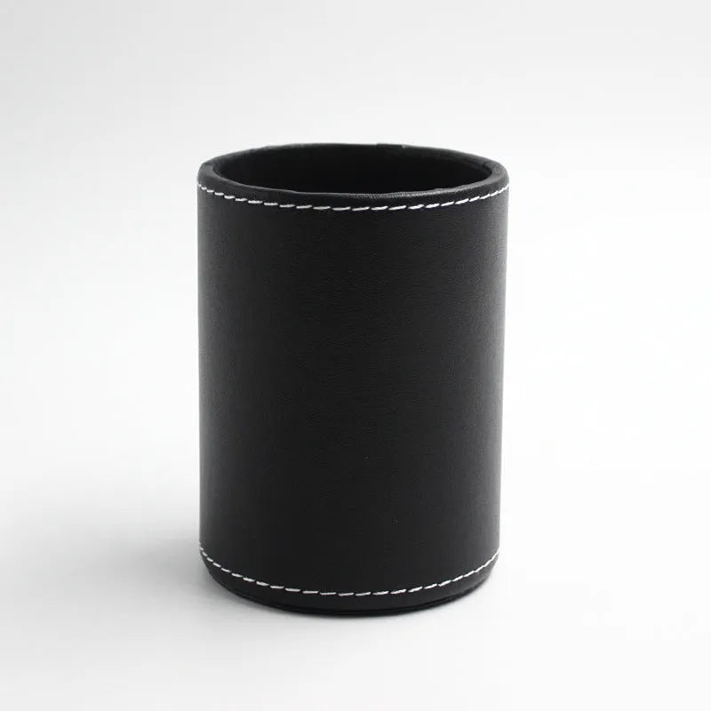 Round black leather pen holder with 8.0cm diameter on a desk