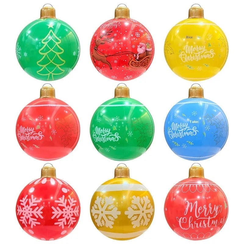 Large red inflatable Christmas ball with snowflake design and LED lights in outdoor garden setting