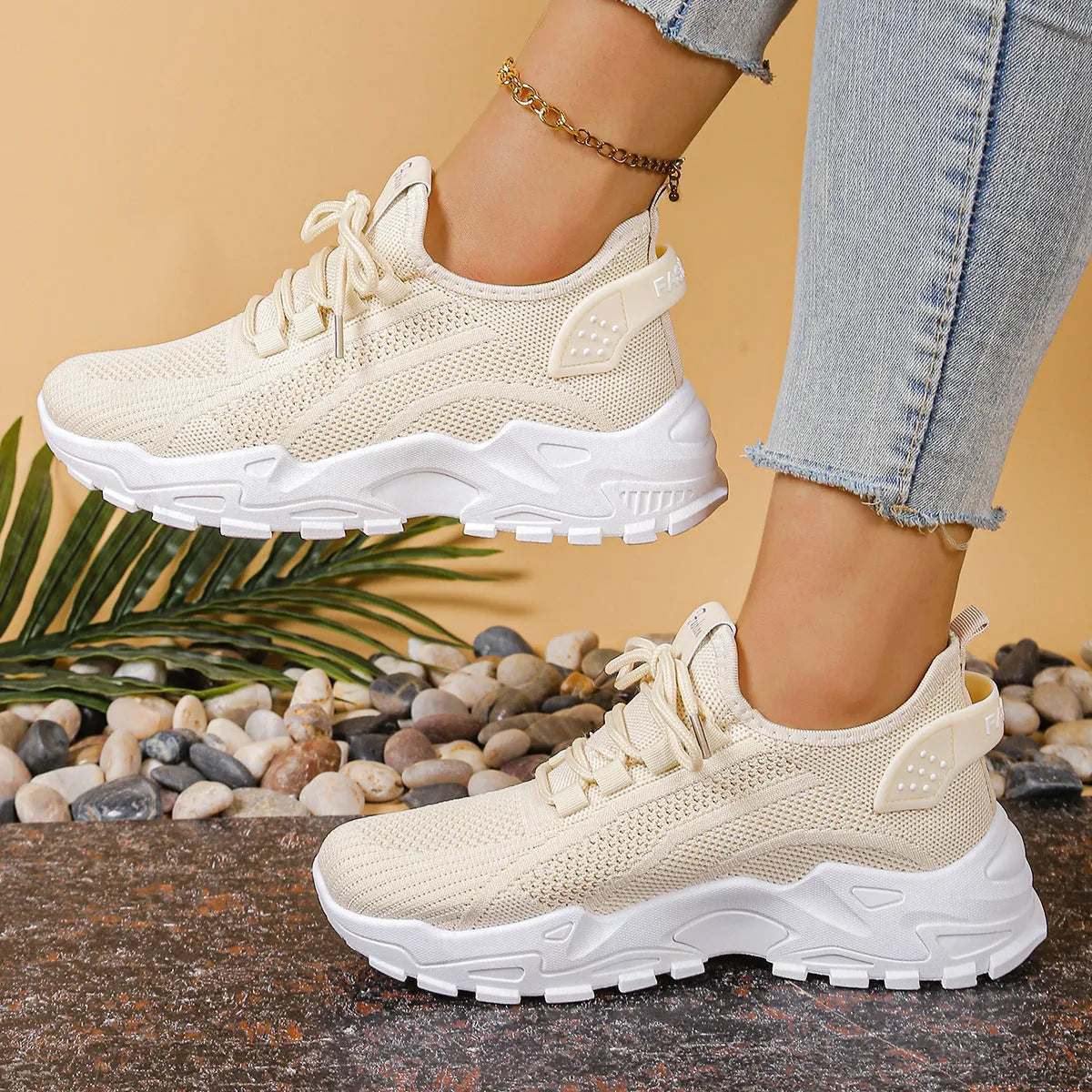Women's low-top sneakers with mesh upper and platform sole in various colours.