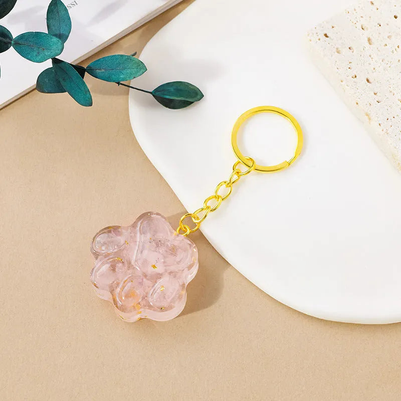 Small natural crystal cat's paw shaped pendant on a metal keyring, available in various crystal colours.
