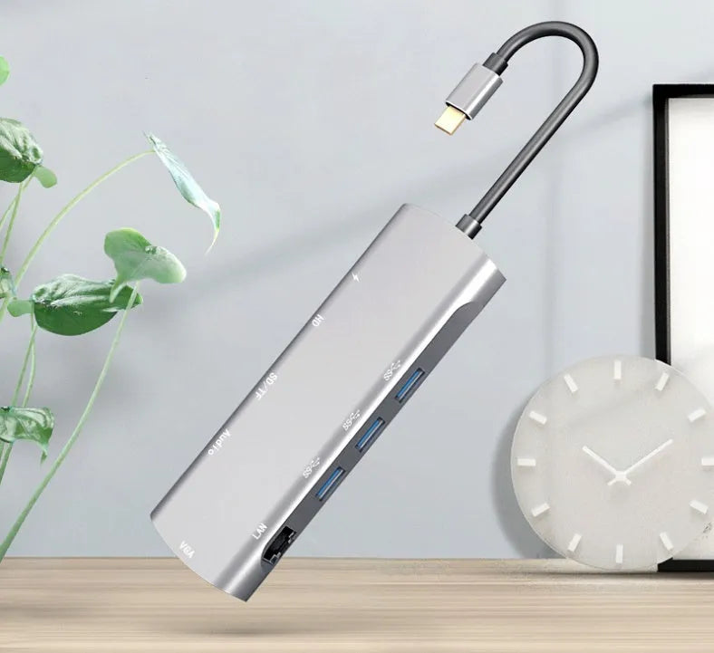 Grey aluminium USB-C docking station showing HDMI, VGA, USB 3.0, and power delivery ports