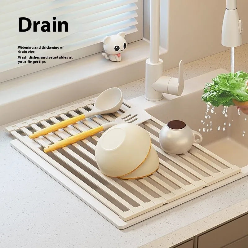 Milky white foldable stainless steel kitchen draining rack shown next to a sink.