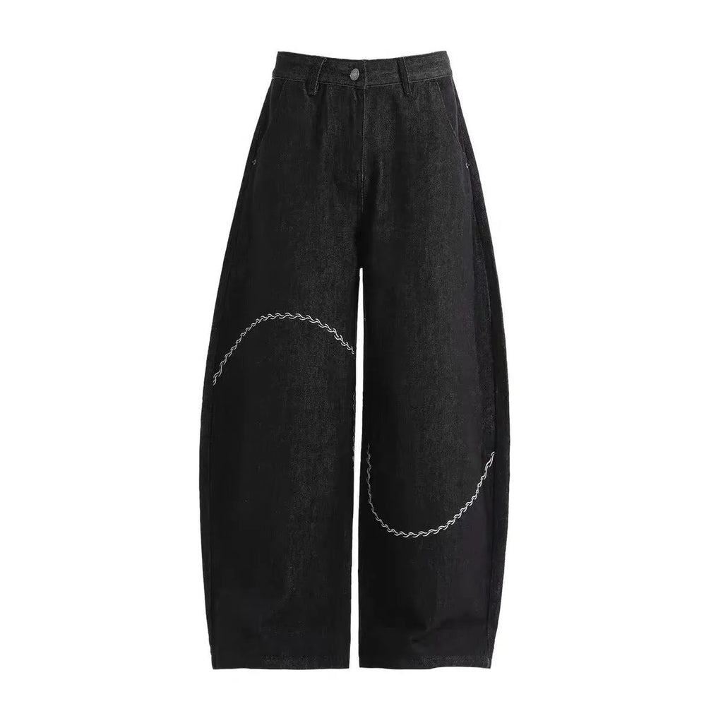 Black straight-leg denim trousers with a mid waist and zip fly, laid flat.