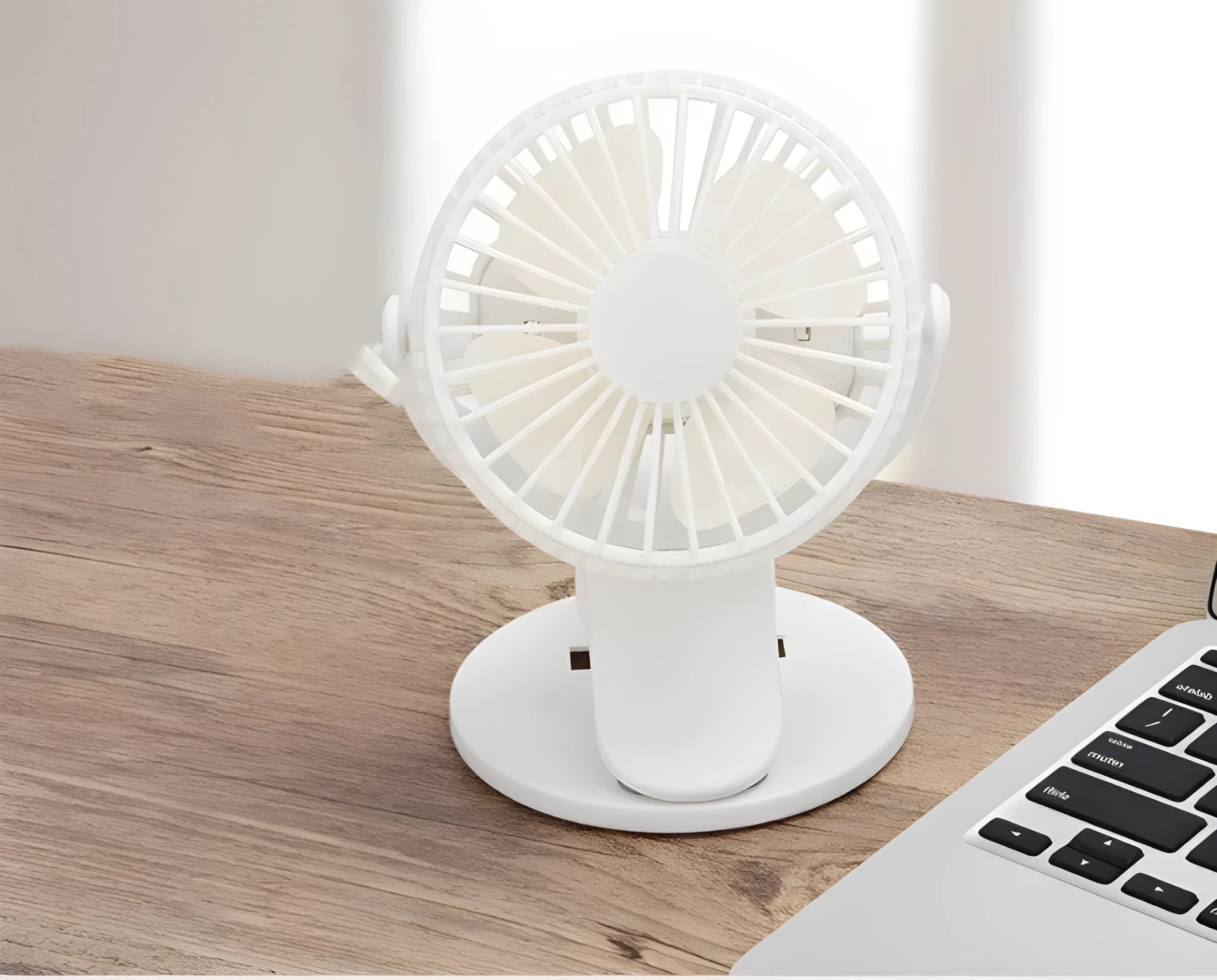 White USB rechargeable brushless clip fan attached to a desk edge