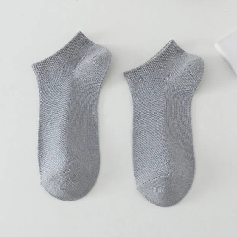 A pair of solid colour low-cut boat socks made from breathable polyester, shown in one of six available colour options.