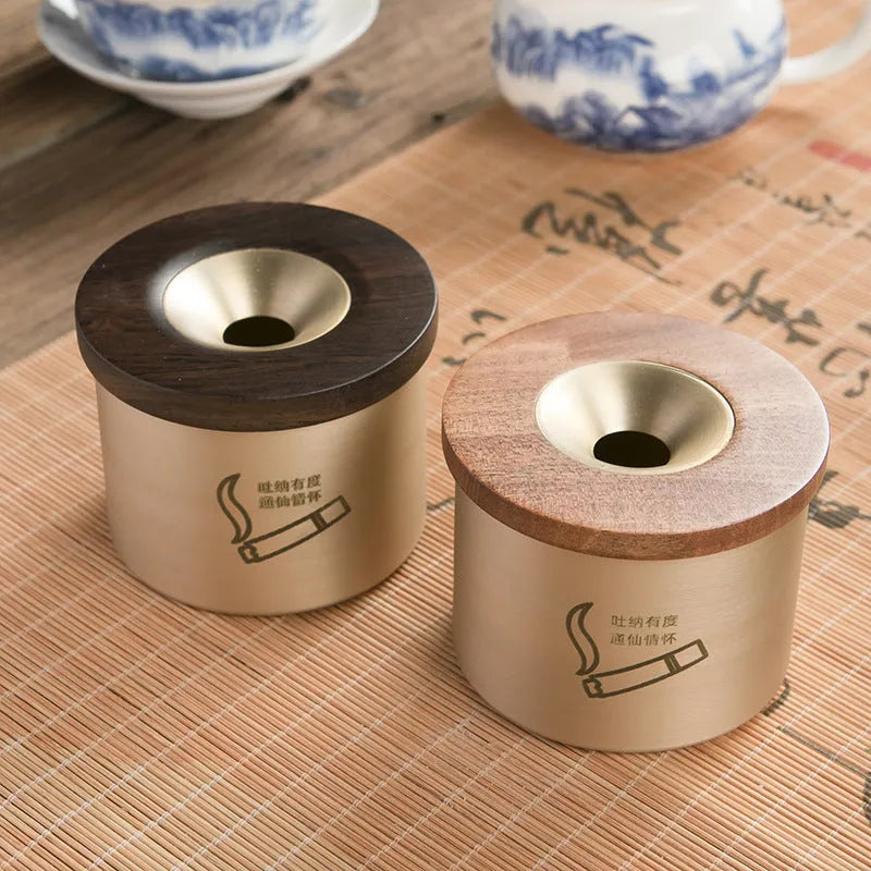 Brass retro ashtray with wooden lid in copper finish on living room table