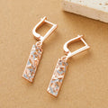 A pair of women's rectangular two-tone hollow stud earrings with a geometric design.