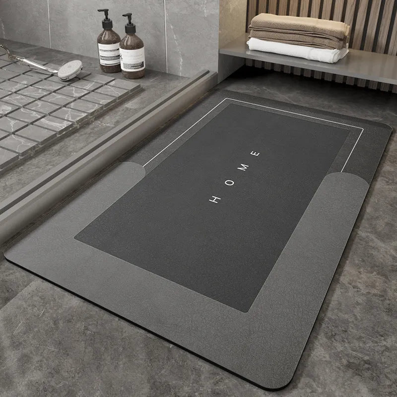 Blended fabric bathroom floor mat in blue colour, shown in an oval shape on a tiled floor.