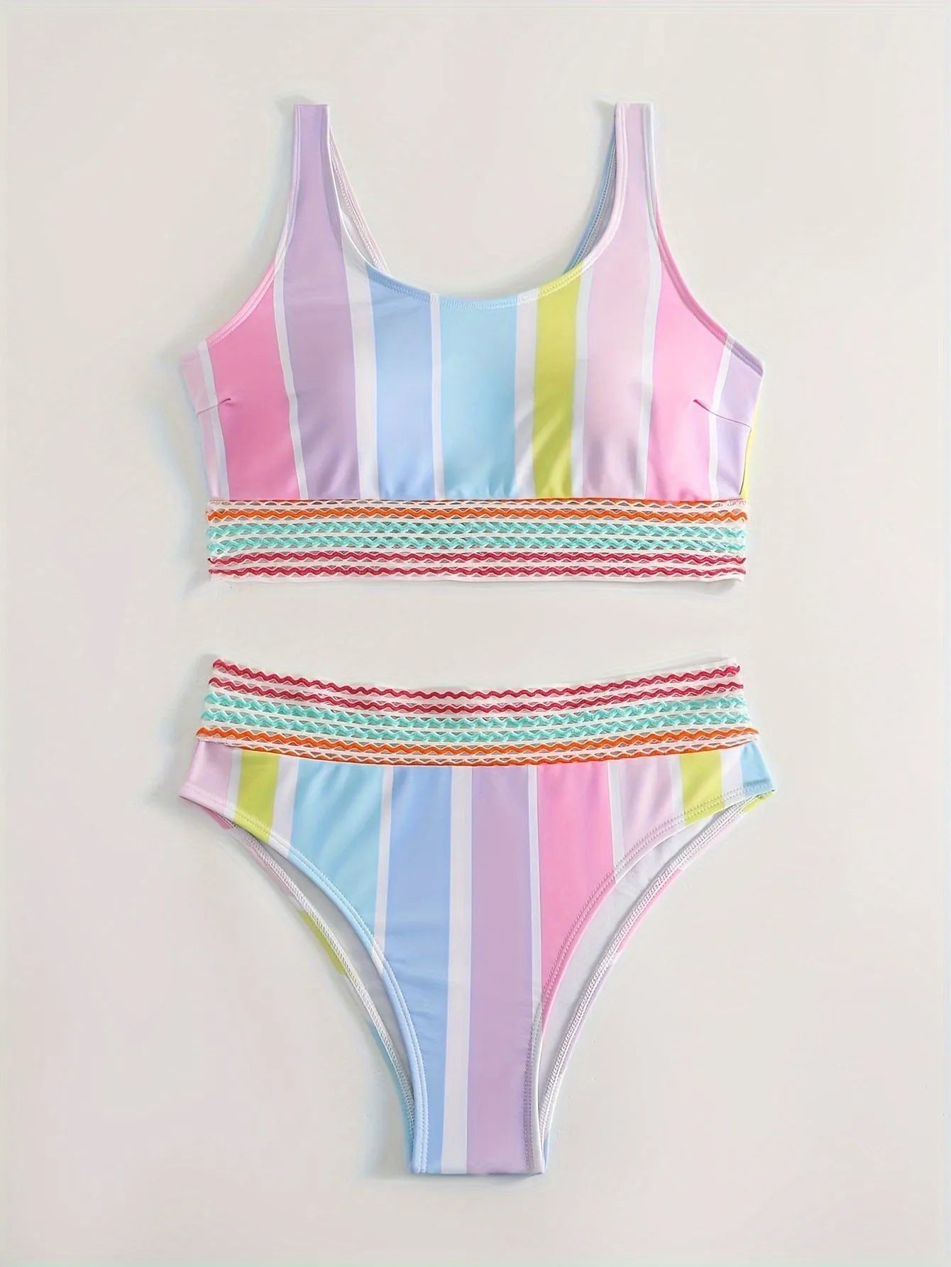 Women's striped two-piece bikini set in a sports casual design on a mannequin.