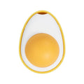 Soft plush catnip ball toy in fried egg shape stuck to a wall, with a cat playing.