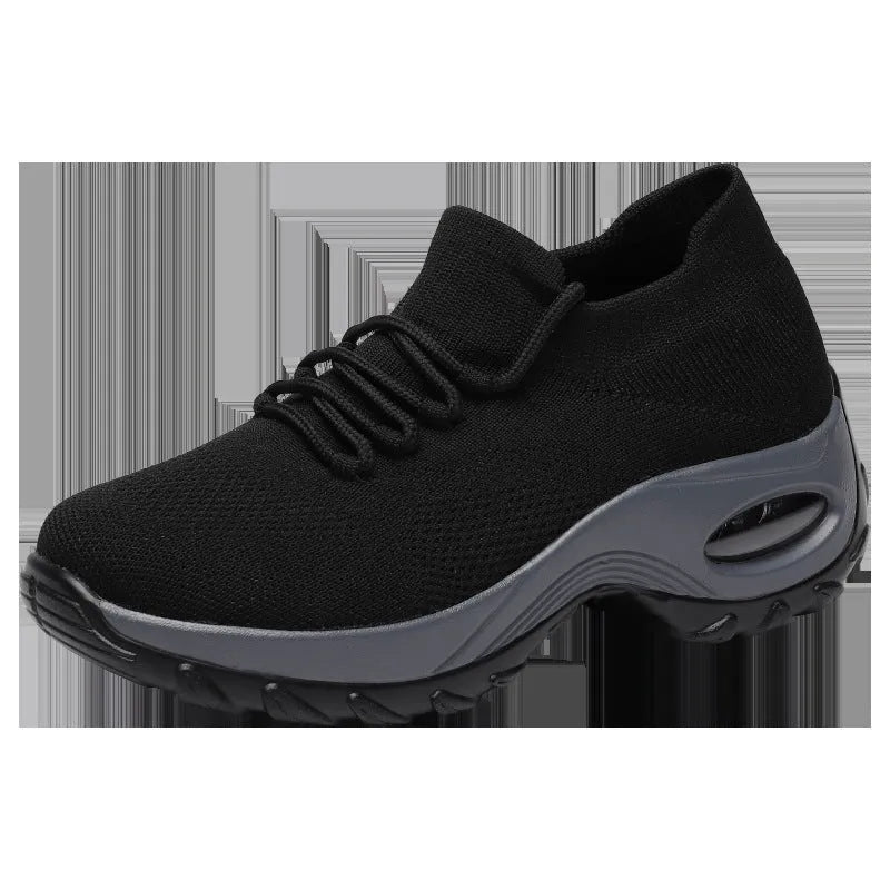 Women's flying knit platform sneakers in black with round toe and waterproof sole