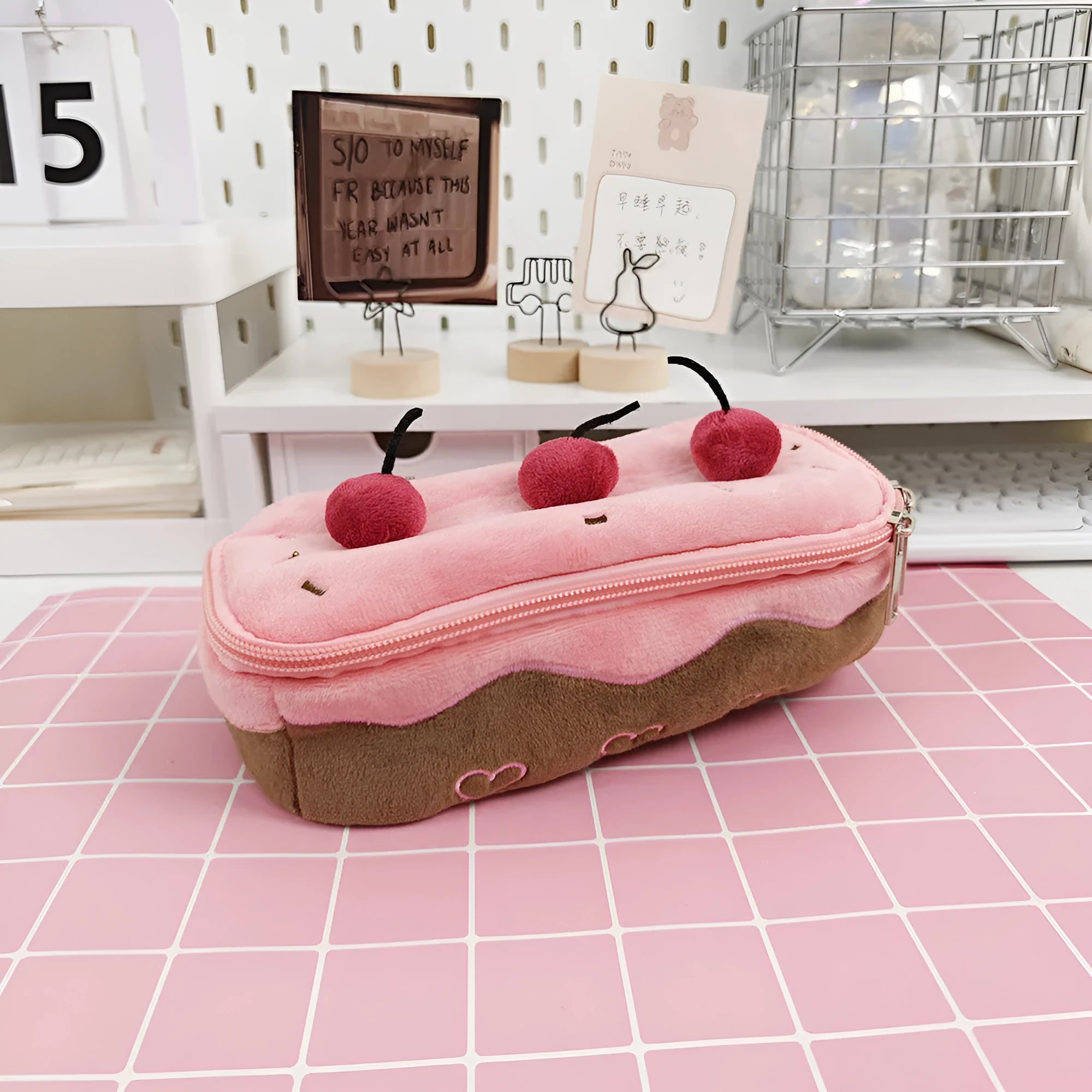 Red velvet pencil bag with cherry cake pattern print, open to show empty interior.
