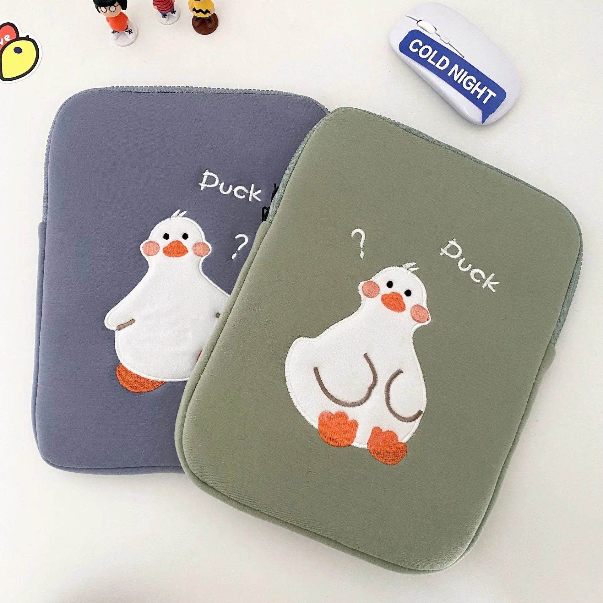 Blue cotton tablet case with embroidered cartoon duck design and zipper opening
