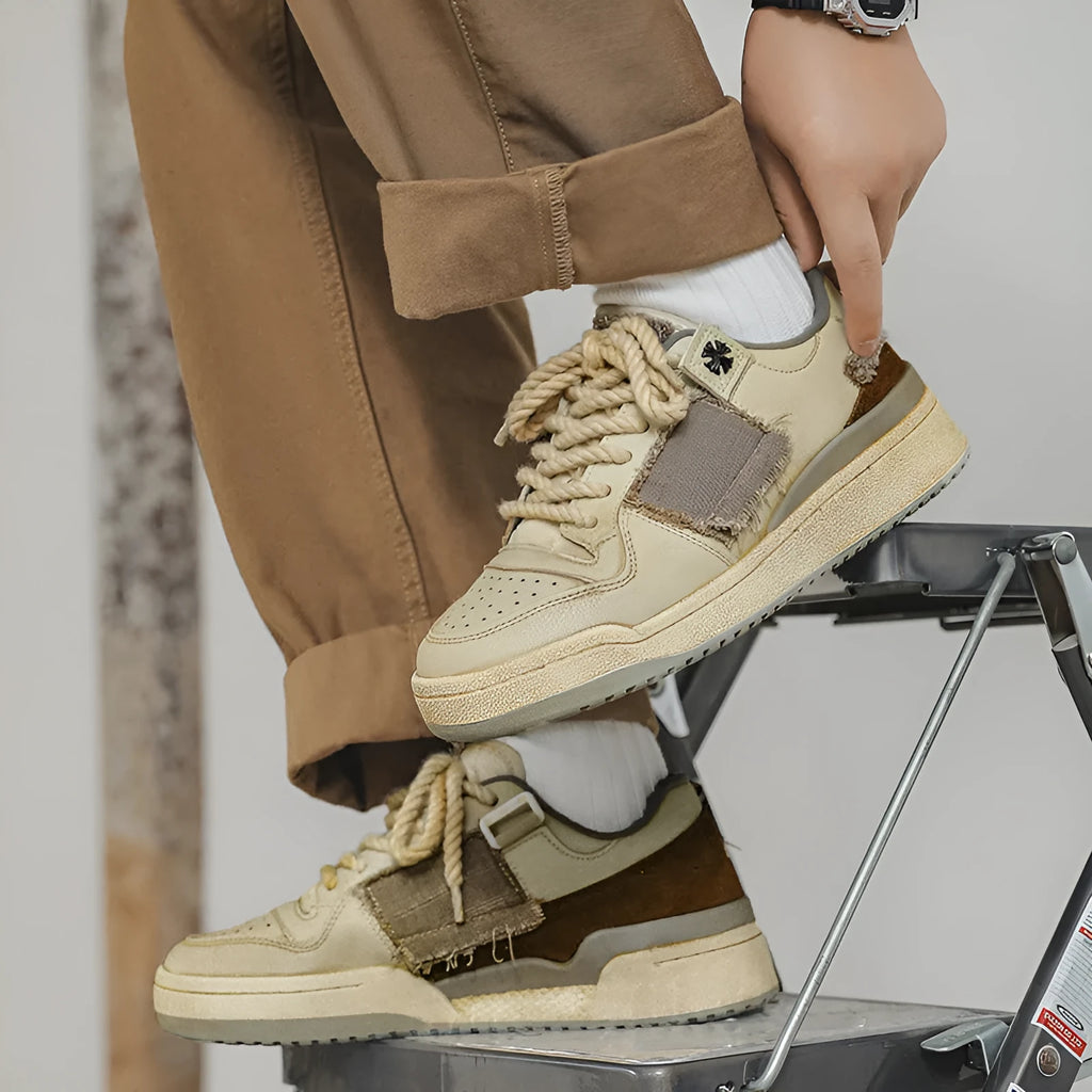 Beige low-top casual skate shoes with lace-up front and flat rubber sole.