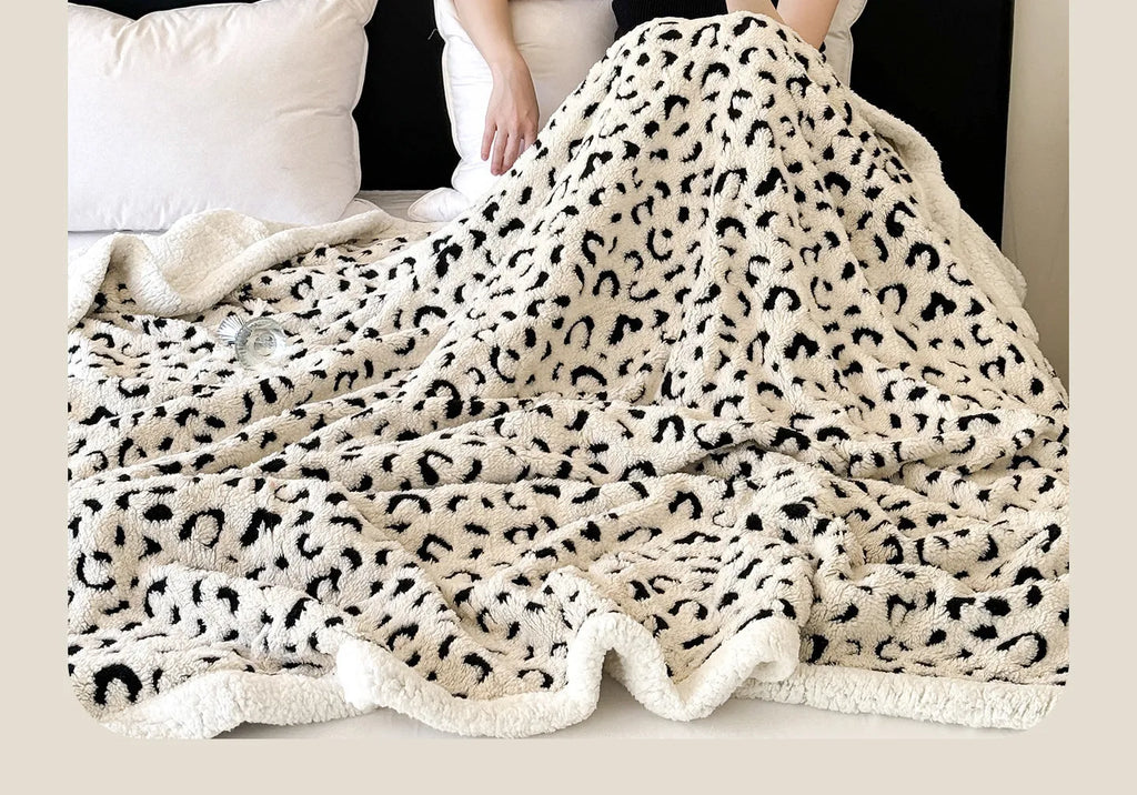 Double-layer leopard jacquard taffeta blanket in camel zebra pattern on a single bed.