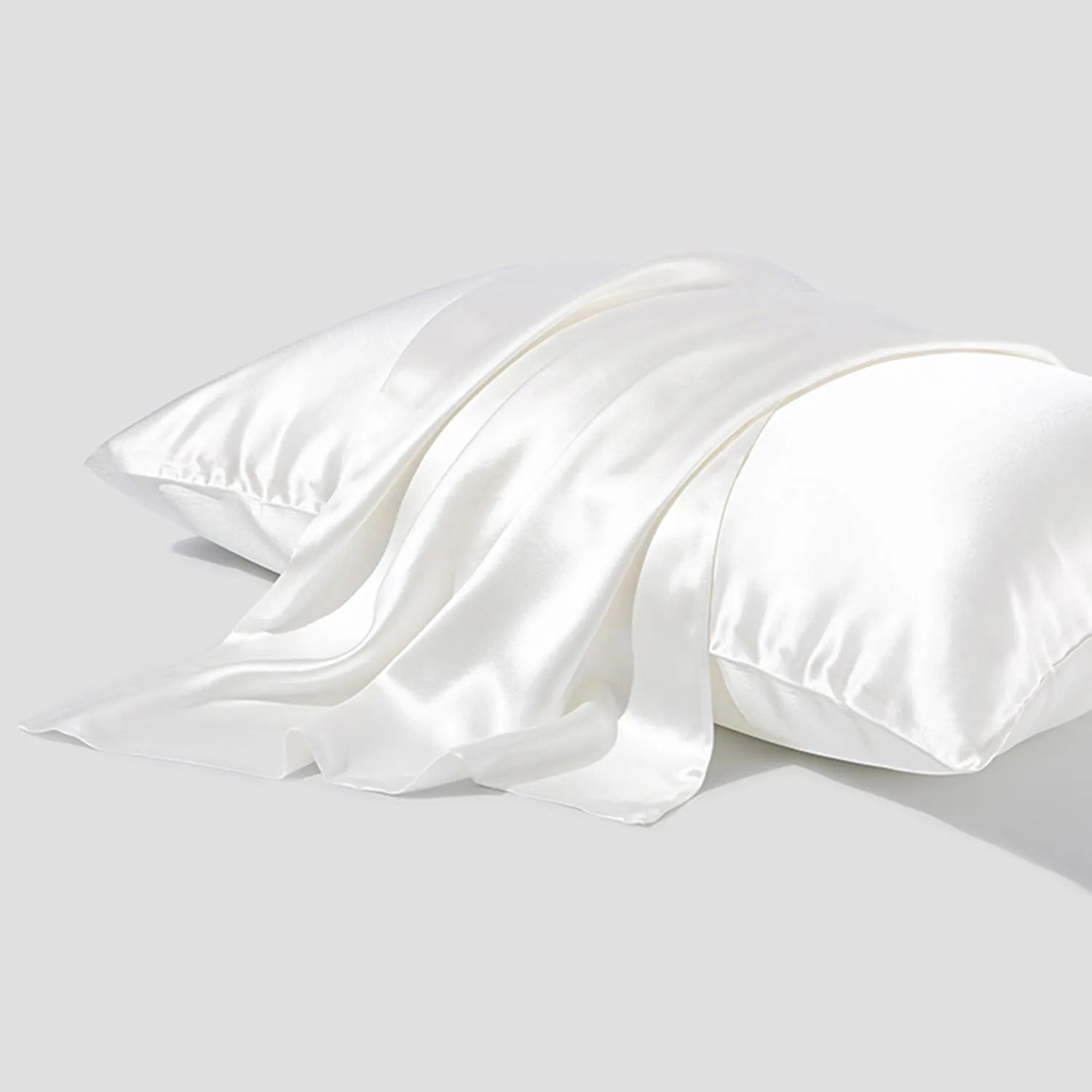 Dark grey silk pillowcase with envelope closure on a bed