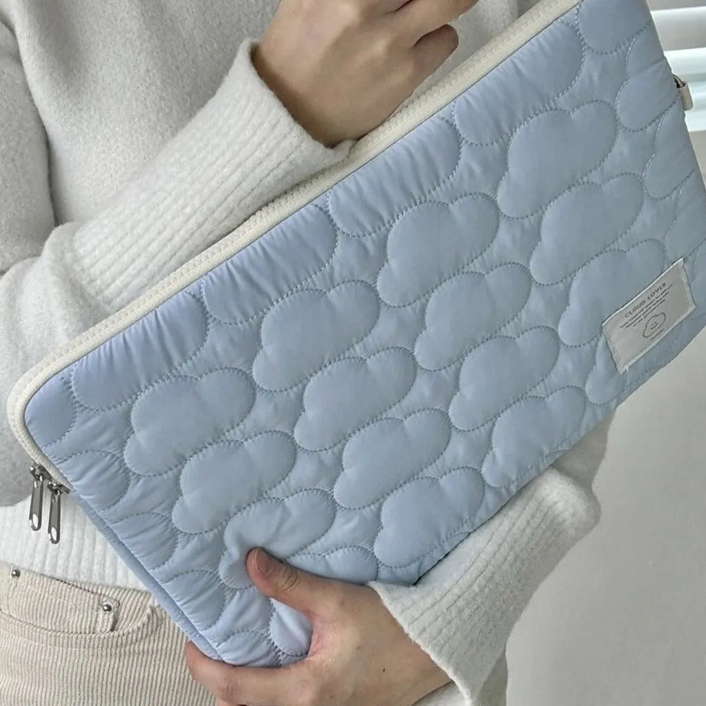 White cotton notebook storage bag with blue cloud embroidery on a table