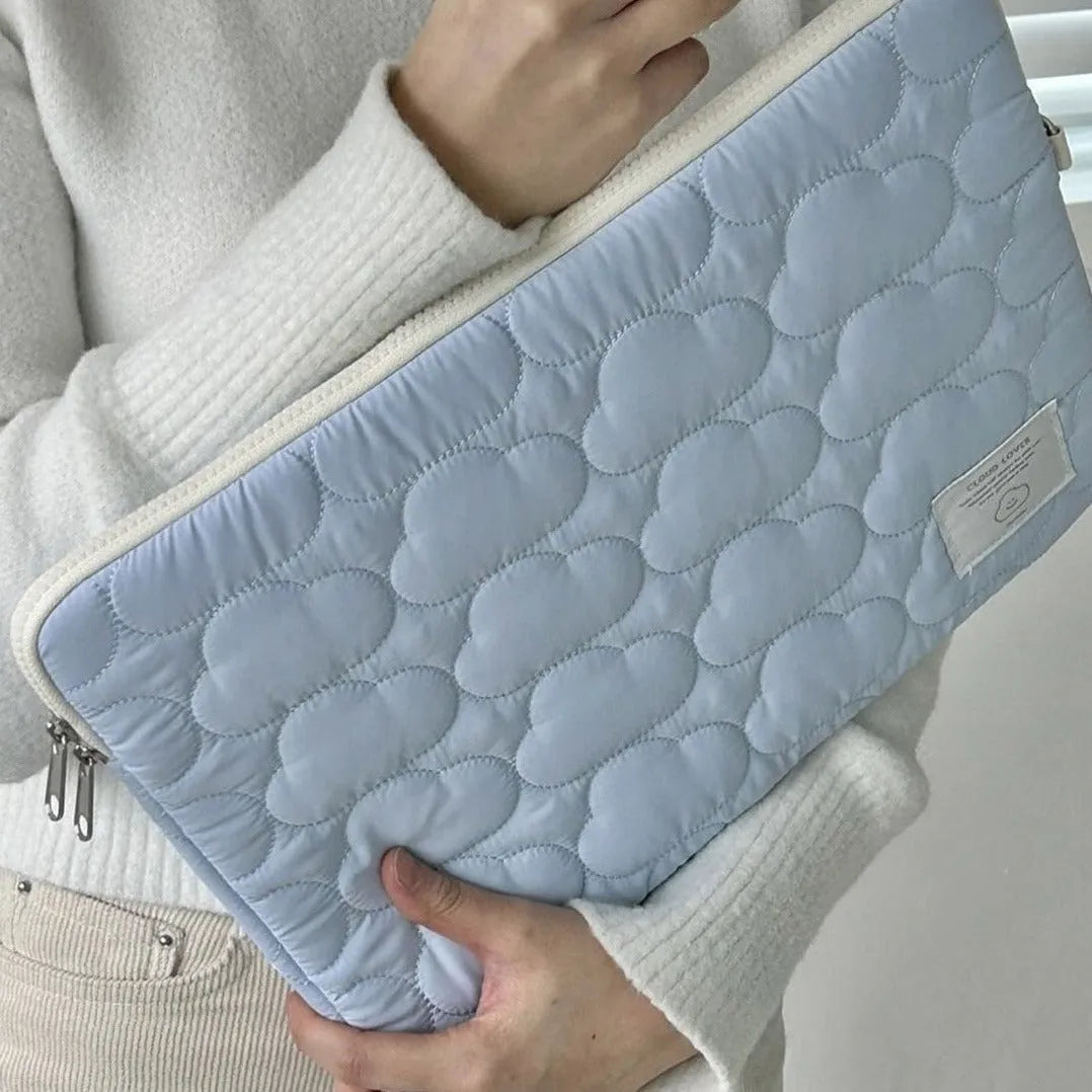 White cotton notebook storage bag with blue cloud embroidery on a table