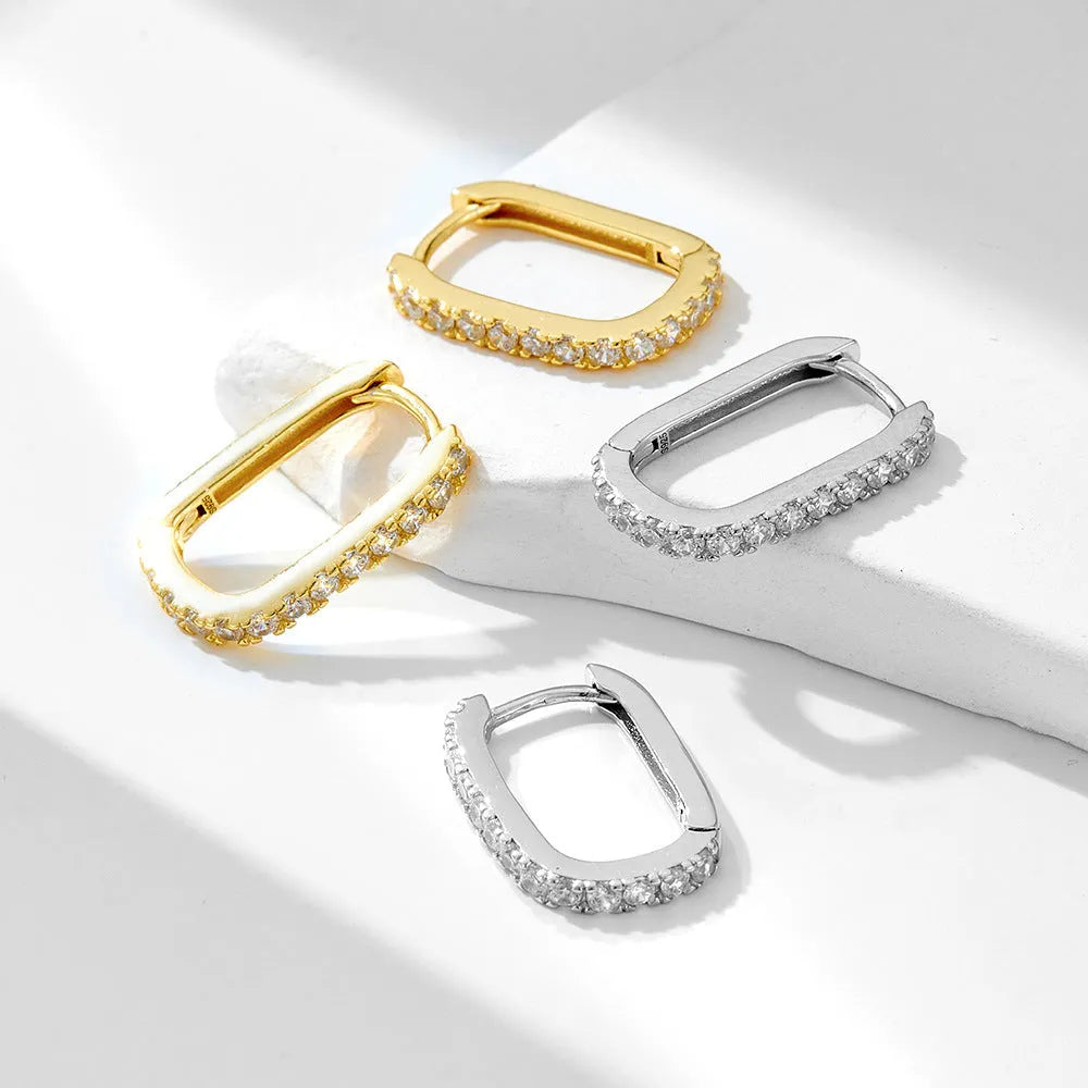 Sterling silver oval zircon ear clip earrings with geometric design in yellow and white options