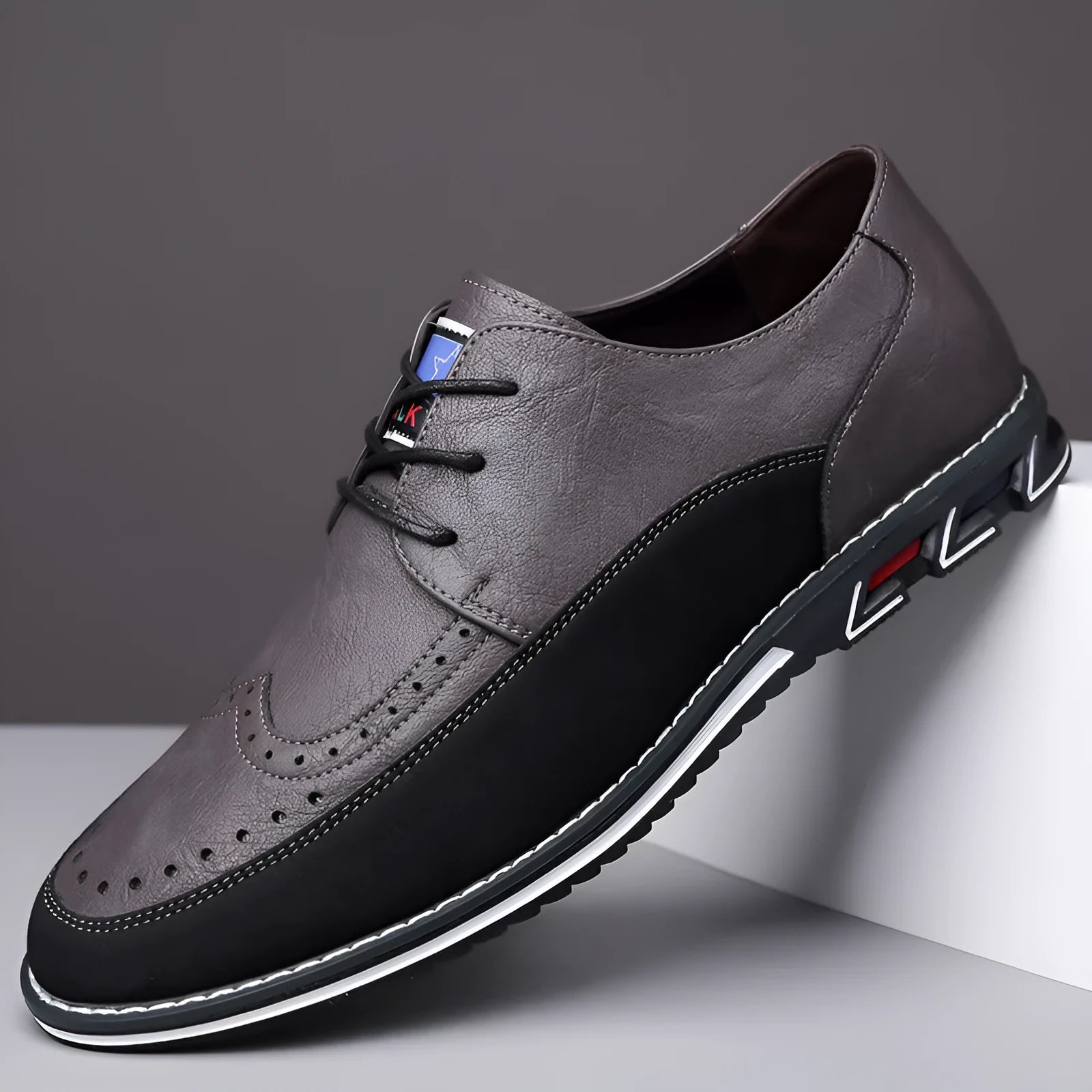 Men's black casual leather slip-on shoes with a rubber sole and visible sewing line details on a leather toe cap.