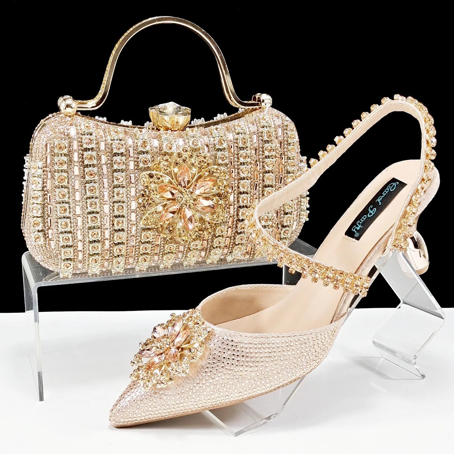 Women's black synthetic leather high-heel shoes with rhinestone ankle chain and matching hard clutch bag.