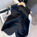 Black satin sleeveless loose-fit vest for women on a hanger