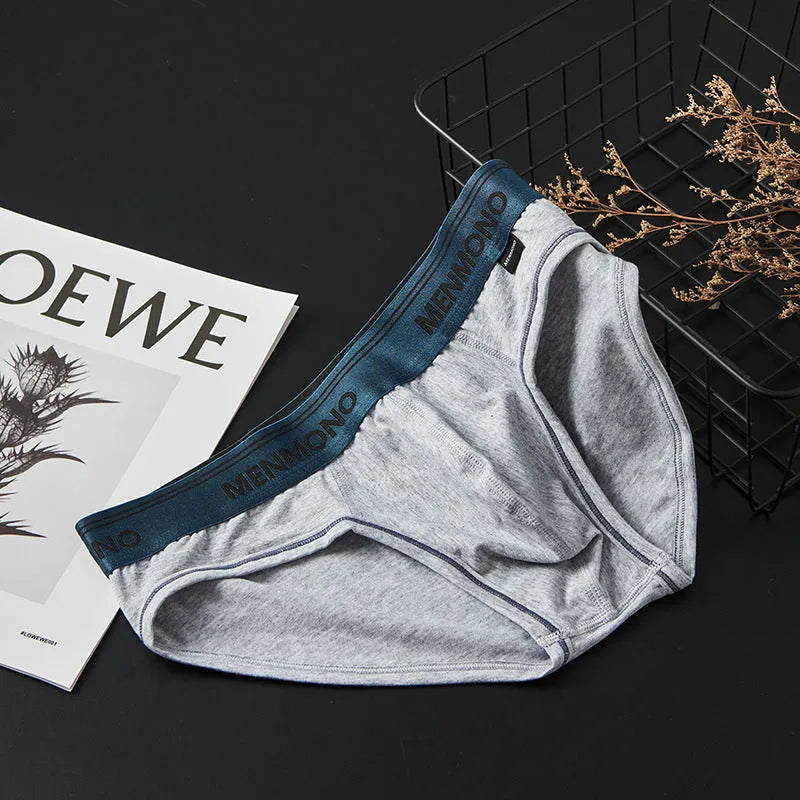 Men's low waist cotton briefs in a selection of solid colours including black and blue, white and red.
