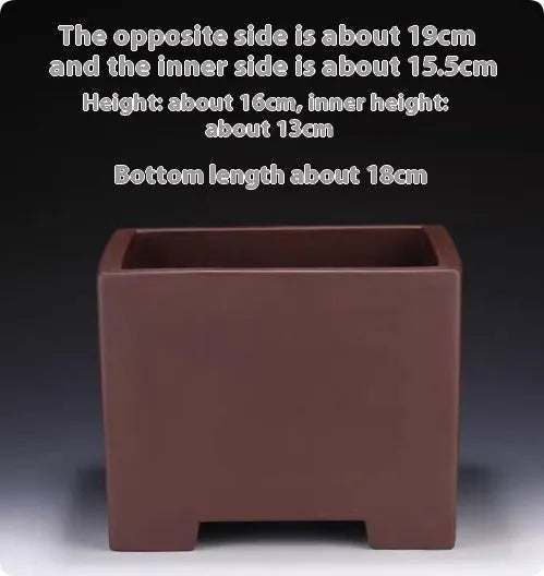 A square purple clay flower pot for succulents or bonsai plants on a tabletop.