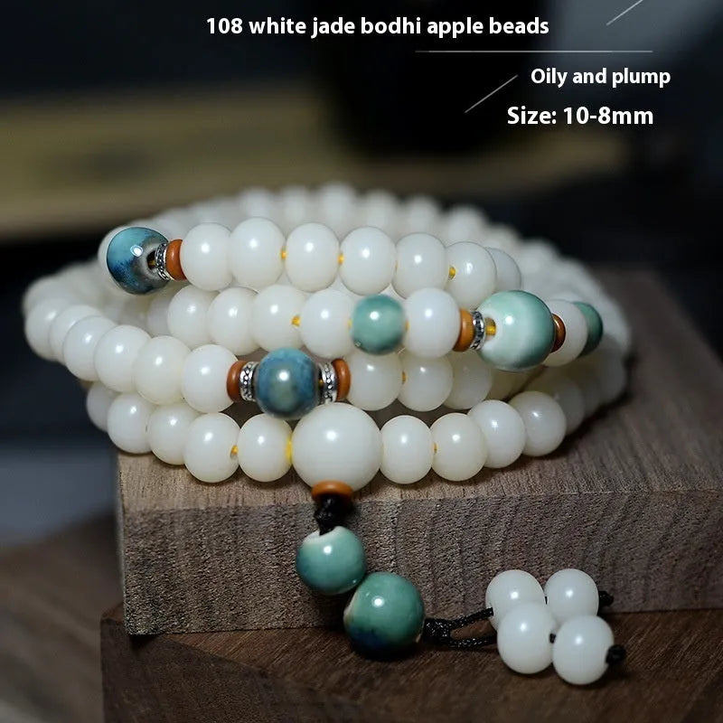 White jade bodhi seed bracelet with 108 flat round beads in 7x9mm and 8x10mm sizes.