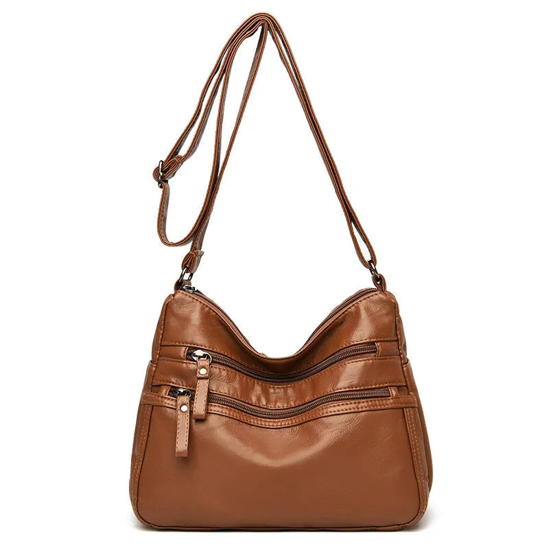 Women's washed leather crossbody bag in solid colour, retro messenger style with adjustable strap and soft handle