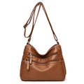Women's washed leather crossbody bag in solid colour, retro messenger style with adjustable strap and soft handle
