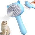 Blue cat-ear shaped steam brush for pet grooming with rubber bristles and a release button.
