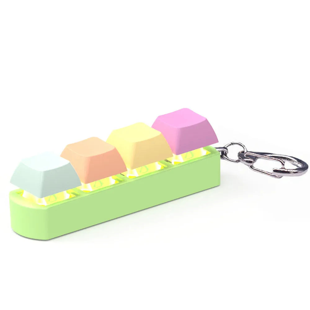 Four-key mechanical keyboard switch tester made of ABS plastic on a desk.