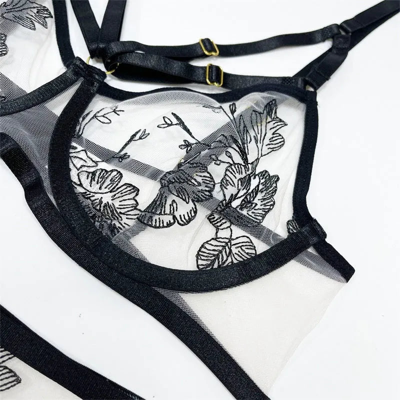 Black women's lace mesh three-piece clothing set with floral print, showing top, trousers, and waist cincher.