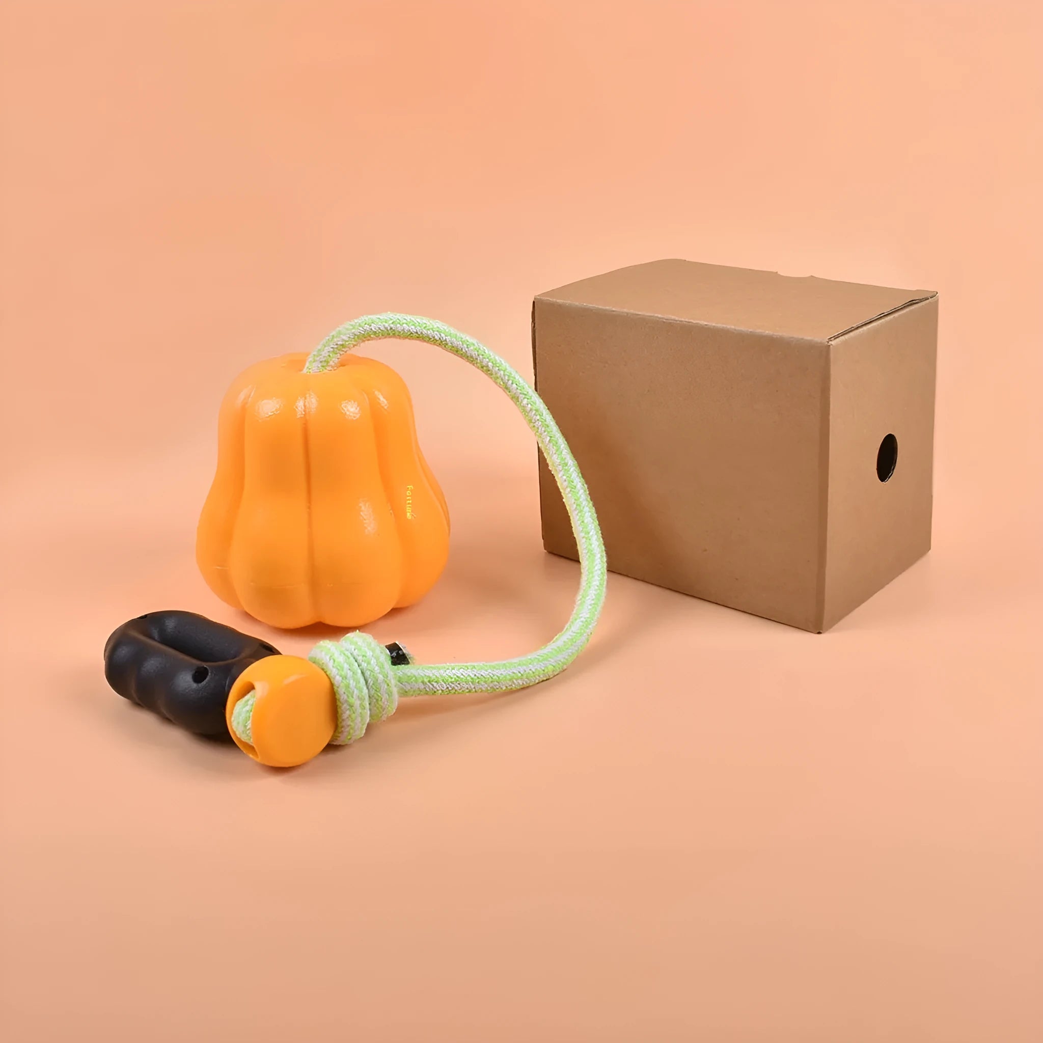 Pumpkin orange plastic dog toy with bite molar texture and an integrated blue tug-of-war rope.