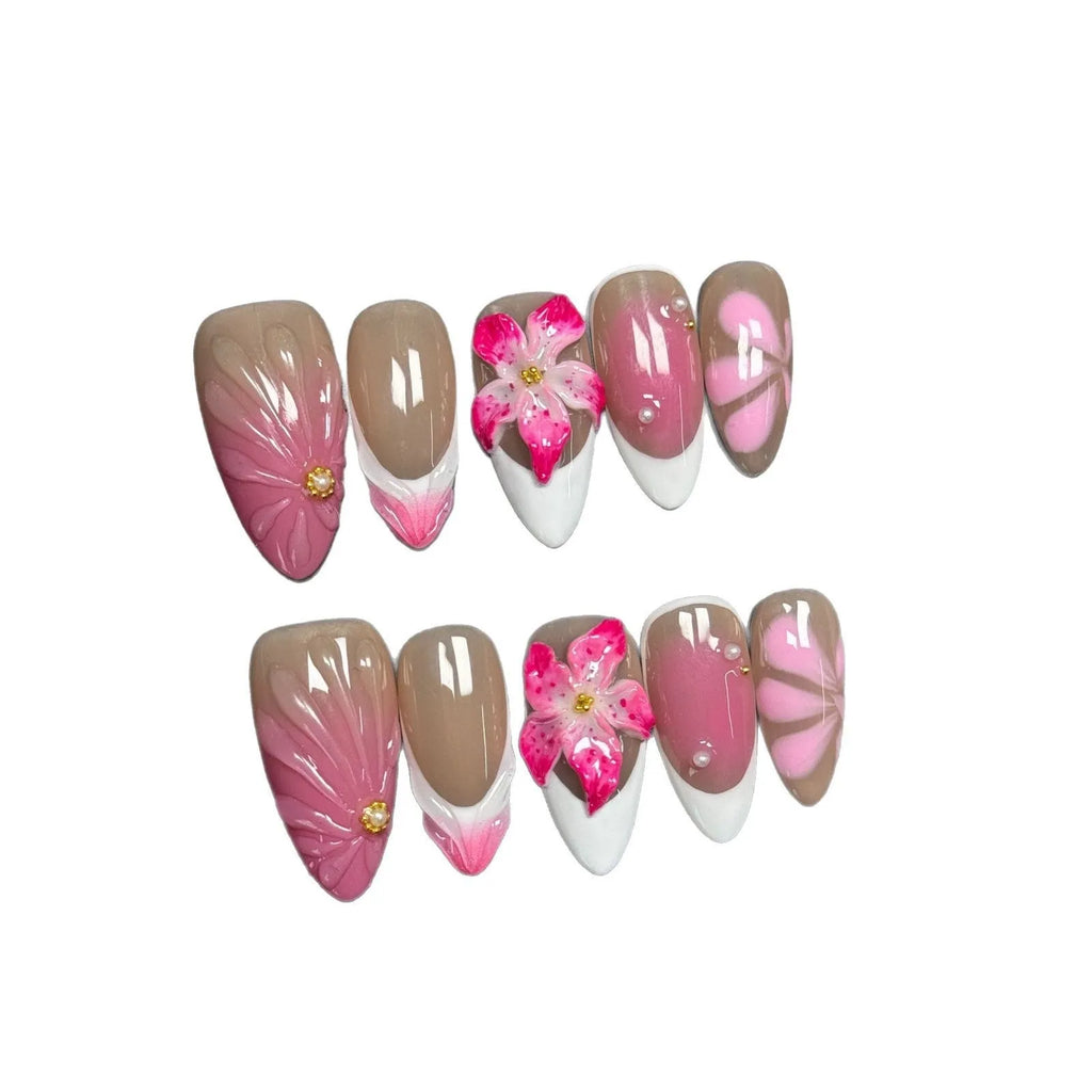 Set of French style artificial nails with white tips and 3D white lily flowers on almond-shaped plastic nail tips.