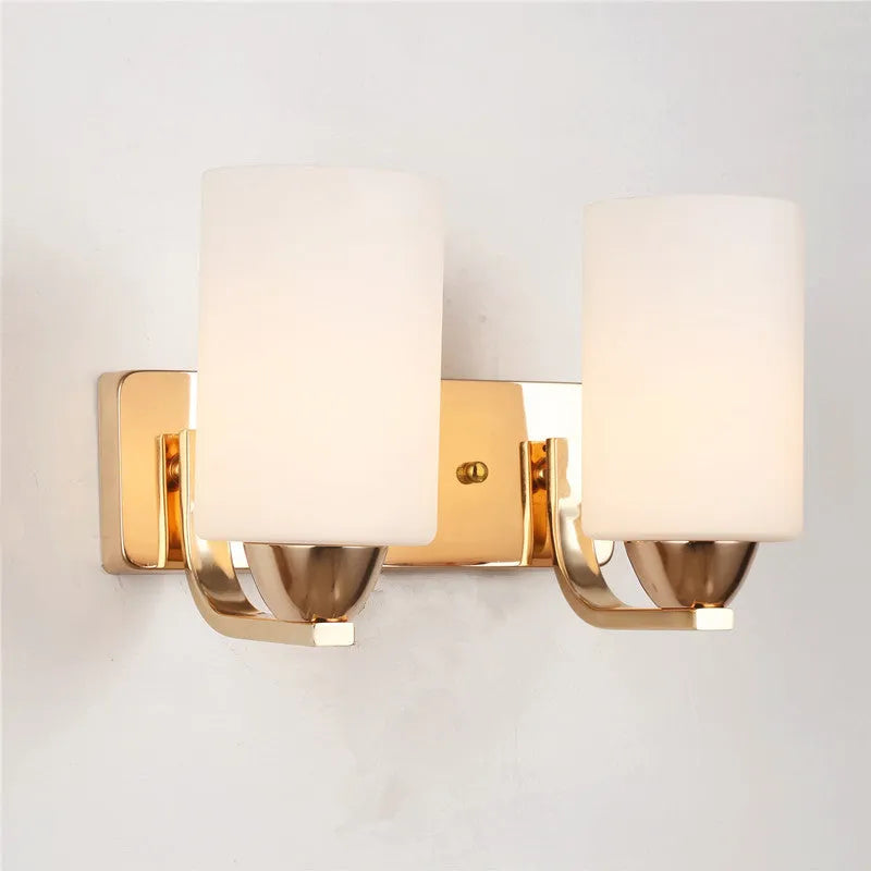 Modern chrome-finished wall lamp with a clear glass shade, shown in a single head configuration.